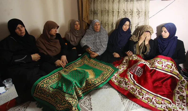 Relatives of Palestinian Kareem Kullab, 25, who was shot dead by Israeli forces during clashes in tents protest where Palestinians demand the right to return to their homeland at the Israel-Gaza border, mourn during his...