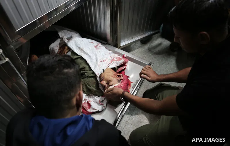 Palestinians look to the body of Emad Ashtawi, 21, who was shot dead by Israeli forces during clashes in tents protest at the Israel-Gaza border, in al-shifa hospital in Gaza City on September 23, 2018. Photo by Mahmoud...