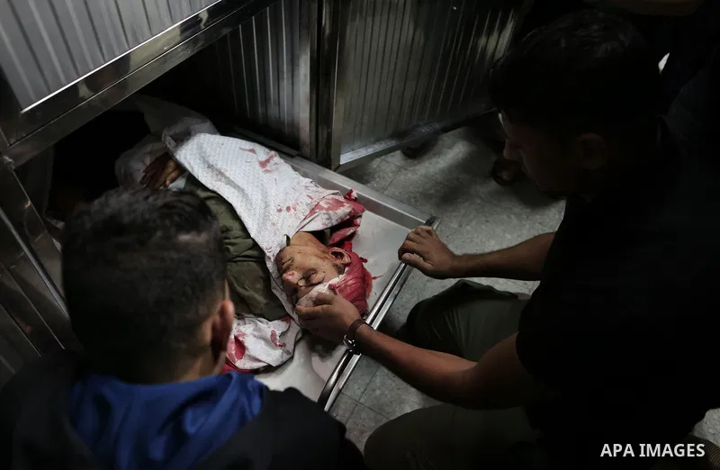 Palestinians look to the body of Emad Ashtawi, 21, who was shot dead by Israeli forces during clashes in tents protest at the Israel-Gaza border, in al-shifa hospital in Gaza City on September 23, 2018. Photo by Mahmoud...