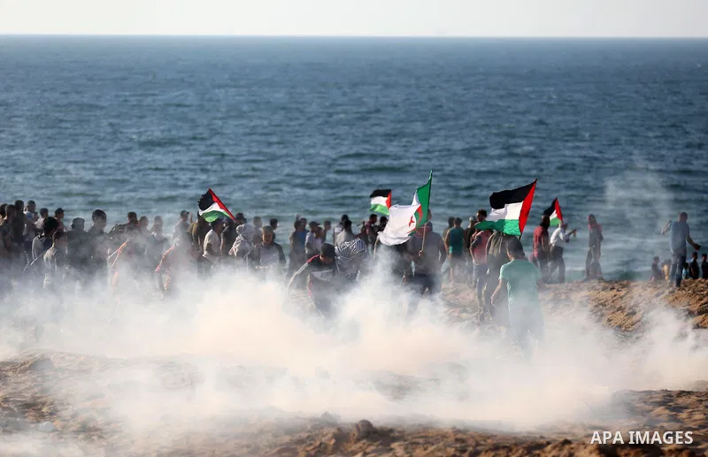 Palestinian protesters gather during clashes with Israeli forces in a demonstration against the Israeli blockade on Gaza Strip, along the Gaza sea barrier on the maritime border with Israel near Kibbutz Zikim, north of B...