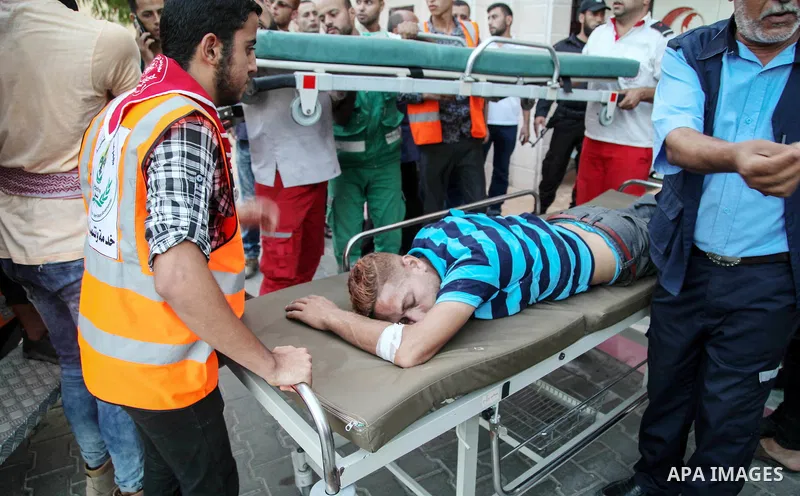 A Palestinian who was wounded during clashes with Israeli forces in a demonstration against the Israeli blockade on Gaza Strip, along the Gaza sea barrier on the maritime border with Israel near Kibbutz Zikim, is carried...
