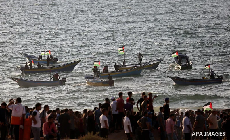 Palestinian protesters gather during clashes with Israeli forces in a demonstration against the Israeli blockade on Gaza Strip, along the Gaza sea barrier on the maritime border with Israel near Kibbutz Zikim, north of B...