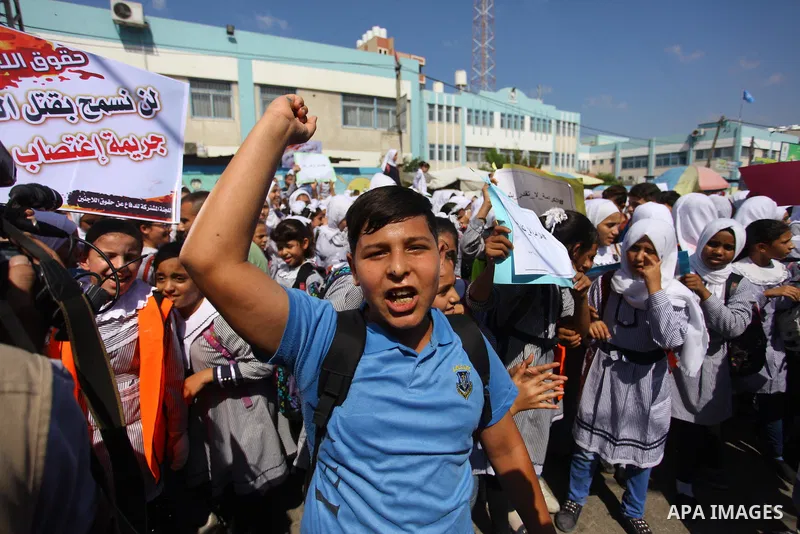 Palestinian students take part during a protest against the United States decision to stop funding and backing the United Nations Relief and Works Agency (UNRWA) in Jabalia in the northern Gaza Strip on September 25, 201...