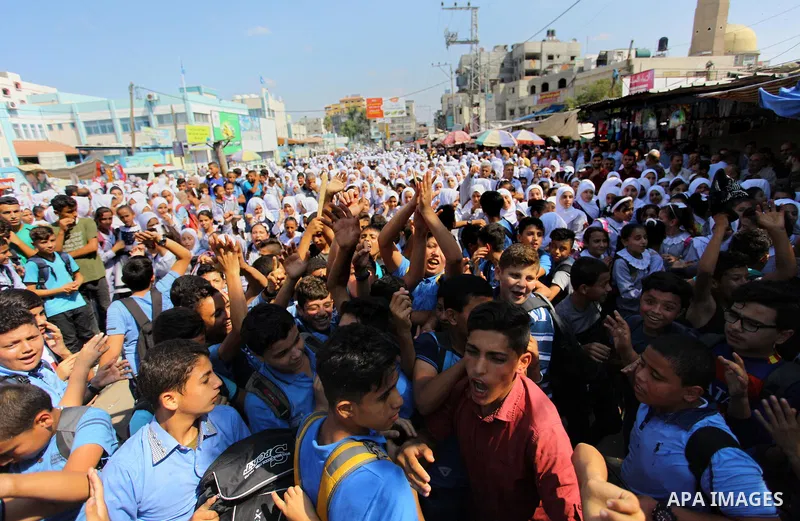 Palestinian students take part during a protest against the United States decision to stop funding and backing the United Nations Relief and Works Agency (UNRWA) in Jabalia in the northern Gaza Strip on September 25, 201...