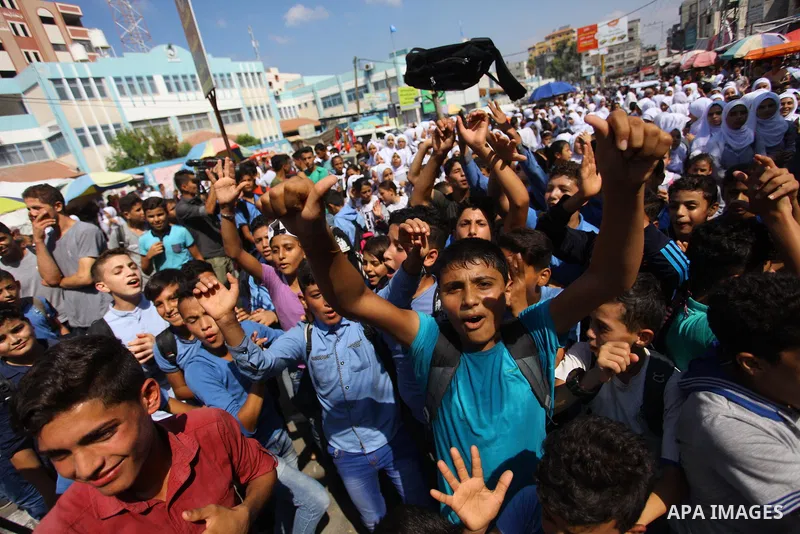 Palestinian students take part during a protest against the United States decision to stop funding and backing the United Nations Relief and Works Agency (UNRWA) in Jabalia in the northern Gaza Strip on September 25, 201...