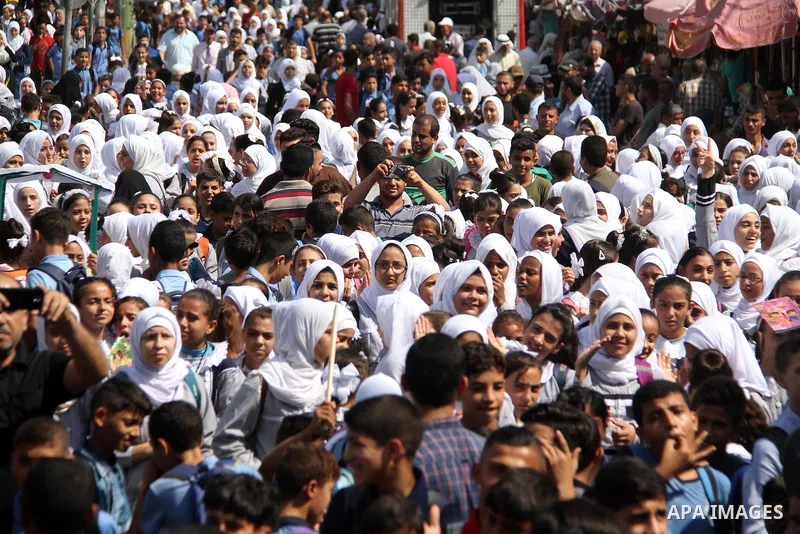 Palestinian students take part during a protest against the United States decision to stop funding and backing the United Nations Relief and Works Agency (UNRWA) in Jabalia in the northern Gaza Strip on September 25, 201...