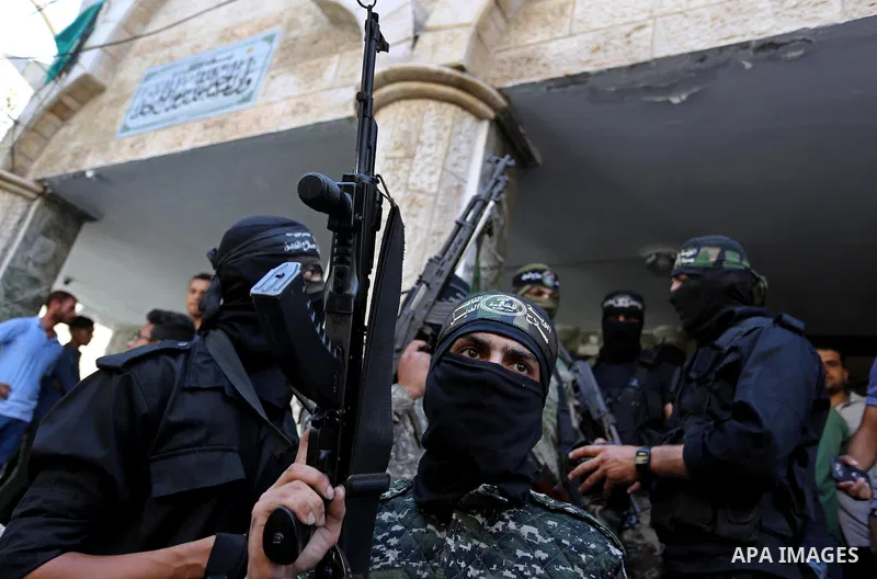 Palestinian militants of the Nasser Salah al-Din Brigades the military wing of the Popular Resistance movement attend the funeral of Palestinian Mohamed Abu Sadek, 21, who was shot dead by Israeli forces during clashes a...
