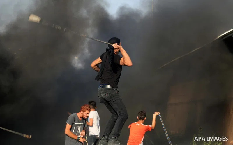 Palestinian protesters gather during clashes with Israeli forces in a demonstration against Israeli blockade on Gaza Strip, at the Erez crossing with Israel in the northern Gaza Strip, on September 26, 2018. Photo by Mah...