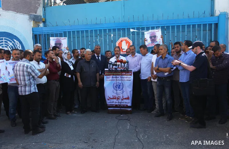 Palestinian employees of United Nations Relief and Works Agency (UNRWA) take part in a protest against job cuts by UNRWA, outside its headquarter office, in Gaza City, on September 27, 2018. Photo by Mahmoud Ajour