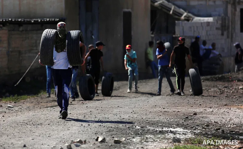 Palestinian protesters hurl stones towards Israeli forces during clashes following a weekly demonstration against the expropriation of Palestinian land by Israel in the village of Kfar Qaddum, near the West Bank city of...