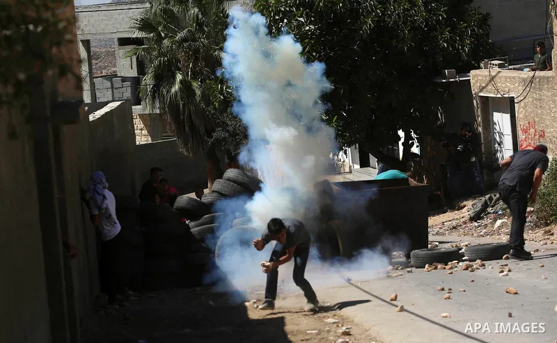 Palestinian protesters hurl stones towards Israeli forces during clashes following a weekly demonstration against the expropriation of Palestinian land by Israel in the village of Kfar Qaddum, near the West Bank city of...