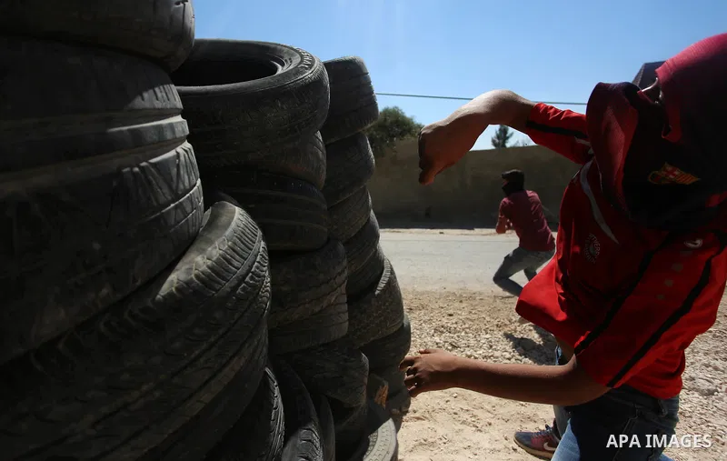 Palestinian protesters hurl stones towards Israeli forces during clashes following a weekly demonstration against the expropriation of Palestinian land by Israel in the village of Kfar Qaddum, near the West Bank city of...