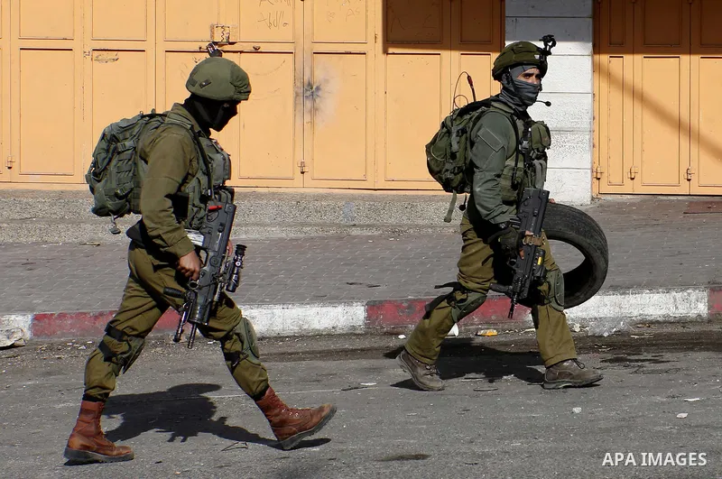 Israeli forces take position during clashes with Palestinian protesters in the West Bank city of Hebron on September 28, 2018. Photo by Wisam Hashlamoun