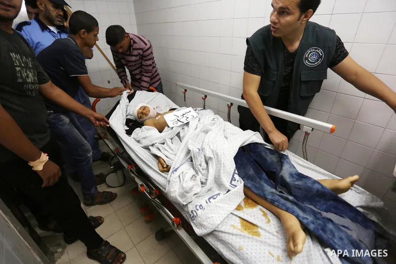 Palestinians gather around the body of Palestinian boy Nasser Musabah, 12, who was shot dead by Israeli forces during clashes in tents protest where Palestinians demand the right to return to their homeland at the Israel...
