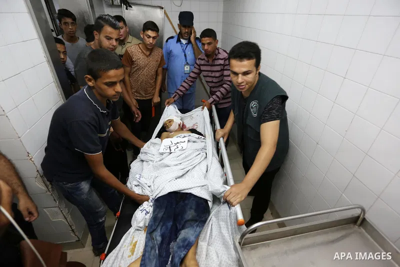 Palestinians gather around the body of Palestinian boy Nasser Musabah, 12, who was shot dead by Israeli forces during clashes in tents protest where Palestinians demand the right to return to their homeland at the Israel...