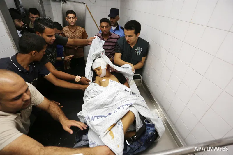 Palestinians gather around the body of Palestinian boy Nasser Musabah, 12, who was shot dead by Israeli forces during clashes in tents protest where Palestinians demand the right to return to their homeland at the Israel...
