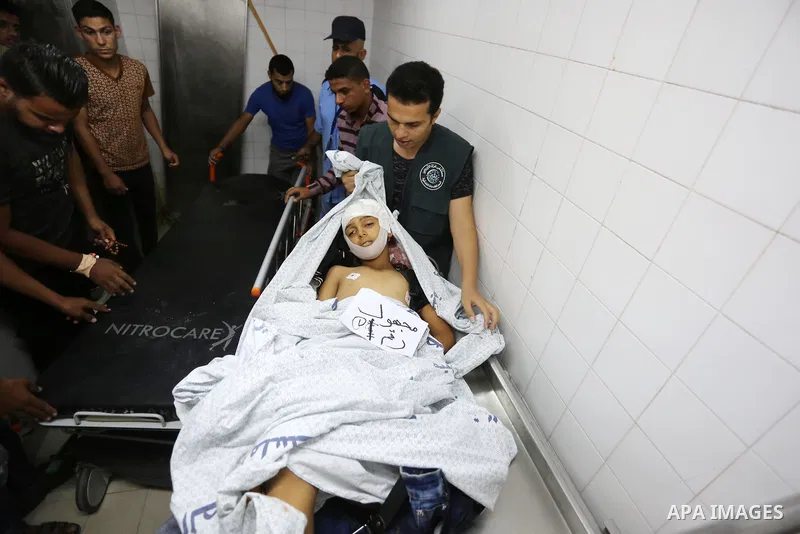 Palestinians gather around the body of Palestinian boy Nasser Musabah, 12, who was shot dead by Israeli forces during clashes in tents protest where Palestinians demand the right to return to their homeland at the Israel...