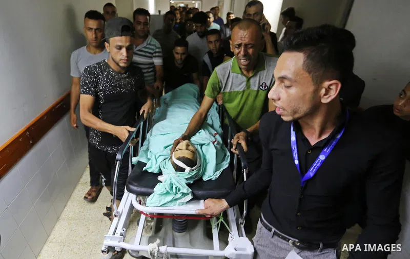 Relatives of Palestinian boy Nasser Musabah, 12, who was shot dead by Israeli forces during clashes in tents protest where Palestinians demand the right to return to their homeland at the Israel-Gaza border, mourn over h...
