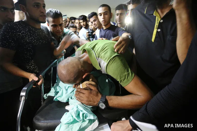 Relatives of Palestinian boy Nasser Musabah, 12, who was shot dead by Israeli forces during clashes in tents protest where Palestinians demand the right to return to their homeland at the Israel-Gaza border, mourn over h...
