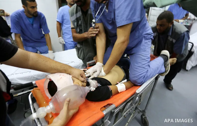 Paramedics carry the body of Palestinian boy Nasser Musabah, 12, who was shot dead by Israeli forces during clashes in tents protest where Palestinians demand the right to return to their homeland at the Israel-Gaza bord...