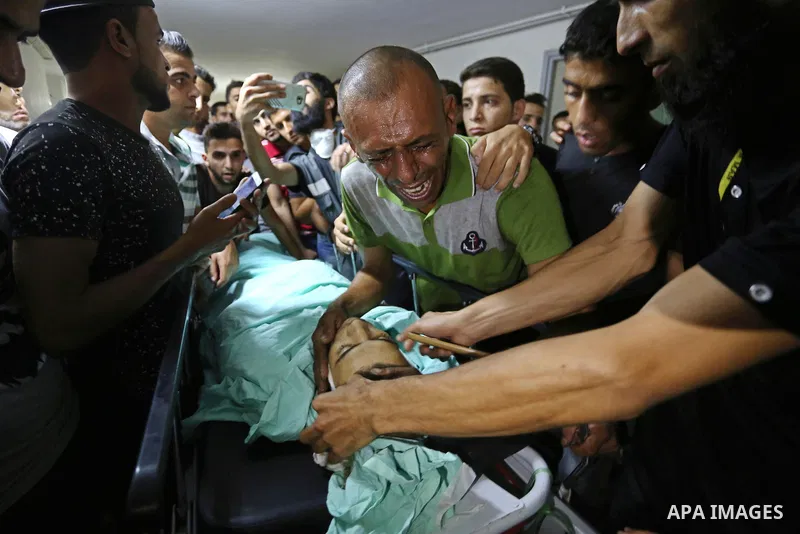Relatives of Palestinian boy Nasser Musabah, 12, who was shot dead by Israeli forces during clashes in tents protest where Palestinians demand the right to return to their homeland at the Israel-Gaza border, mourn over h...