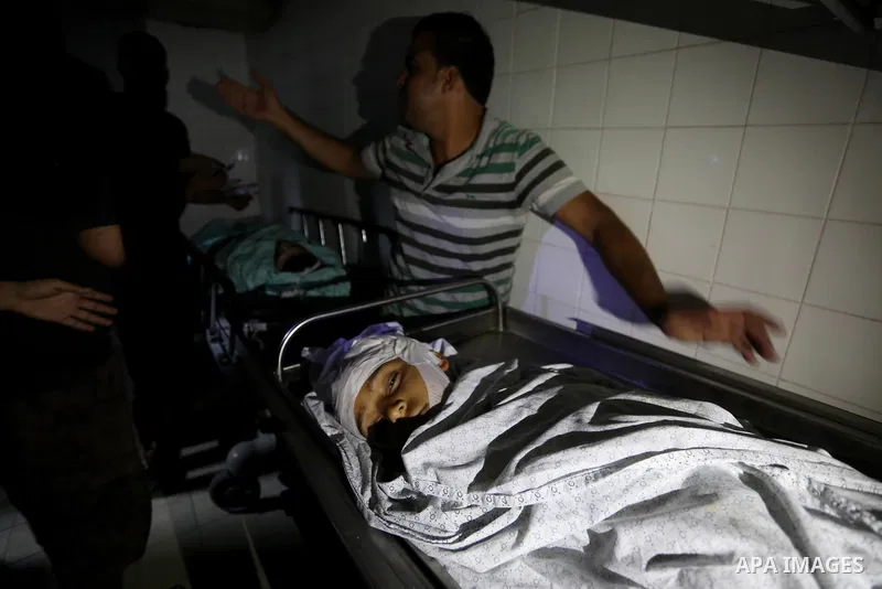 Palestinians mourn over bodies of two Palestinians who were shot dead by Israeli forces during clashes in tents protest where Palestinians demand the right to return to their homeland at the Israel-Gaza border, in a hosp...