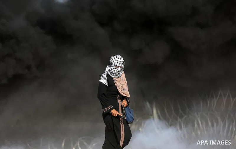 Palestinian protesters gather during clashes with Israeli troops in tents protest where Palestinians demand the right to return to their homeland at the Israel-Gaza border, in Khan Younis in the southern Gaza Strip on Se...