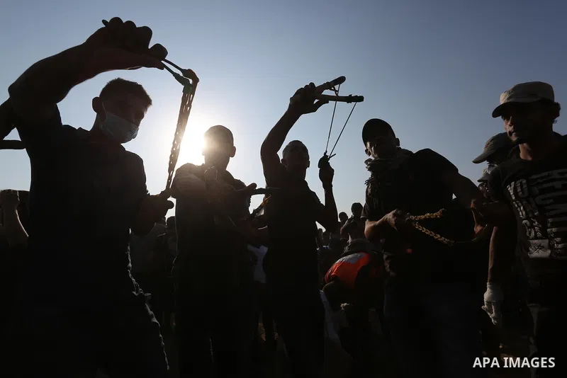 Palestinian protesters gather during clashes with Israeli troops in tents protest where Palestinians demand the right to return to their homeland at the Israel-Gaza border, in Khan Younis in the southern Gaza Strip on Se...