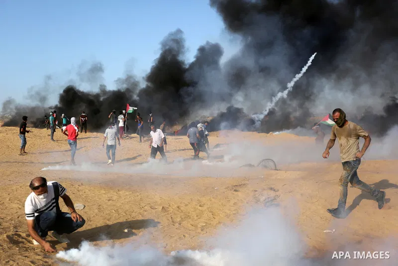 Palestinian protesters gather during clashes with Israeli troops in tents protest where Palestinians demand the right to return to their homeland at the Israel-Gaza border, in Khan Younis in the southern Gaza Strip on Se...