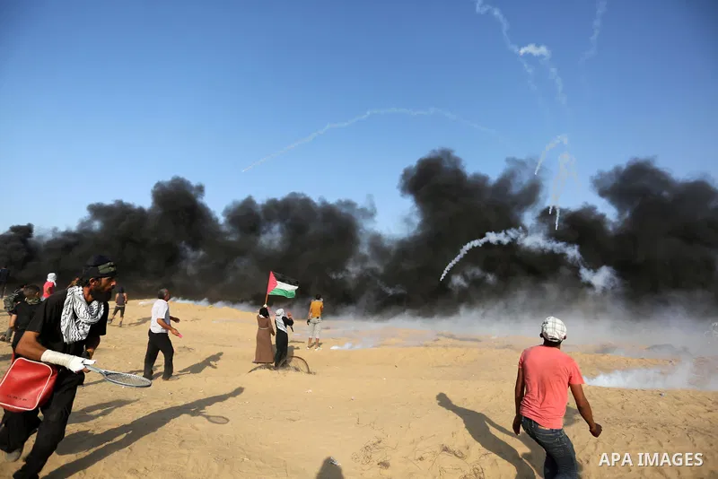 Palestinian protesters gather during clashes with Israeli troops in tents protest where Palestinians demand the right to return to their homeland at the Israel-Gaza border, in Khan Younis in the southern Gaza Strip on Se...