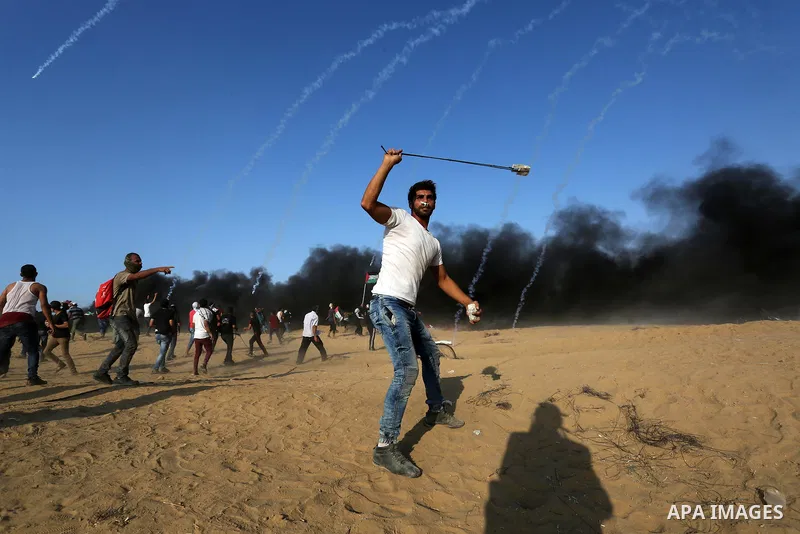 Palestinian protesters gather during clashes with Israeli troops in tents protest where Palestinians demand the right to return to their homeland at the Israel-Gaza border, in Khan Younis in the southern Gaza Strip on Se...