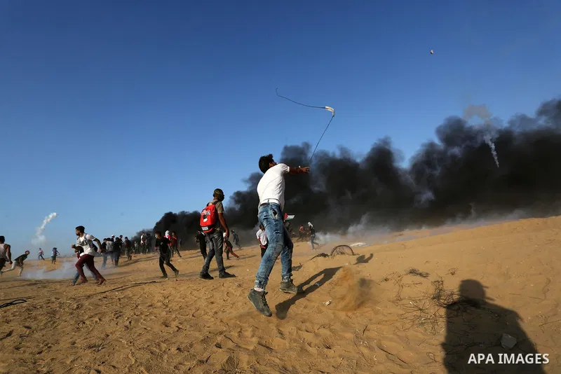Palestinian protesters gather during clashes with Israeli troops in tents protest where Palestinians demand the right to return to their homeland at the Israel-Gaza border, in Khan Younis in the southern Gaza Strip on Se...