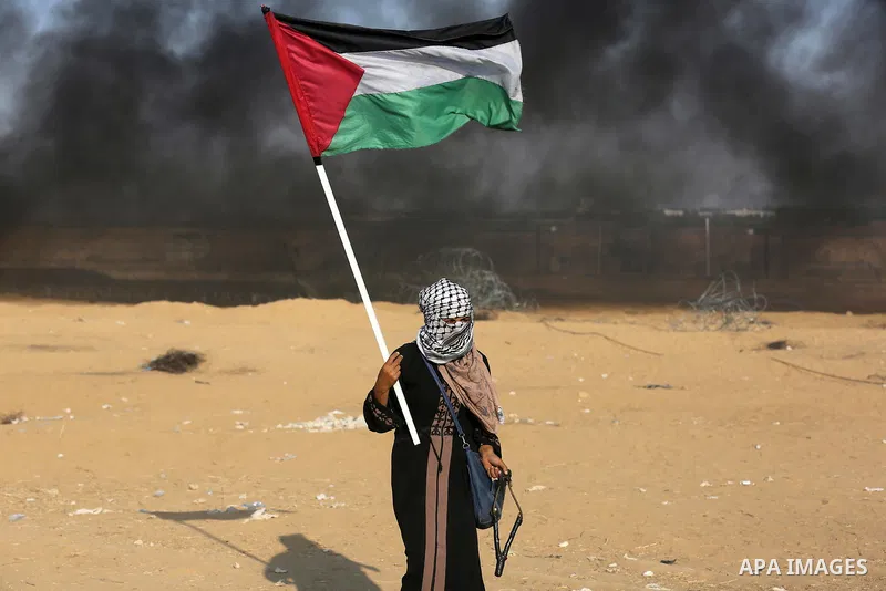 Palestinian protesters gather during clashes with Israeli troops in tents protest where Palestinians demand the right to return to their homeland at the Israel-Gaza border, in Khan Younis in the southern Gaza Strip on Se...