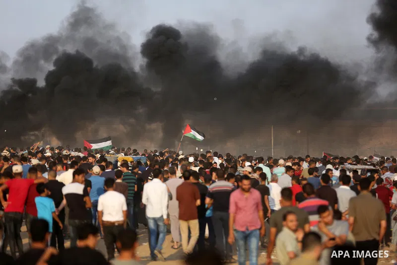 Palestinian protesters gather during clashes with Israeli troops in tents protest where Palestinians demand the right to return to their homeland at the Israel-Gaza border, in Khan Younis in the southern Gaza Strip on Se...