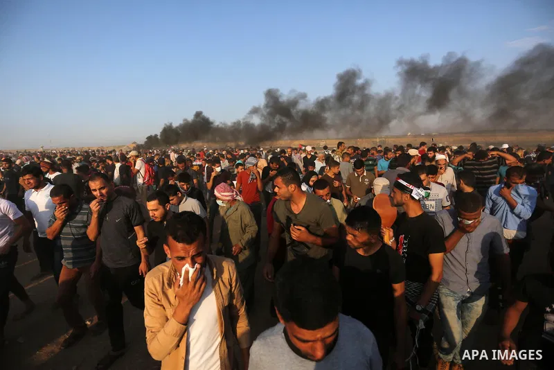 Palestinian protesters gather during clashes with Israeli troops in tents protest where Palestinians demand the right to return to their homeland at the Israel-Gaza border, in Khan Younis in the southern Gaza Strip on Se...