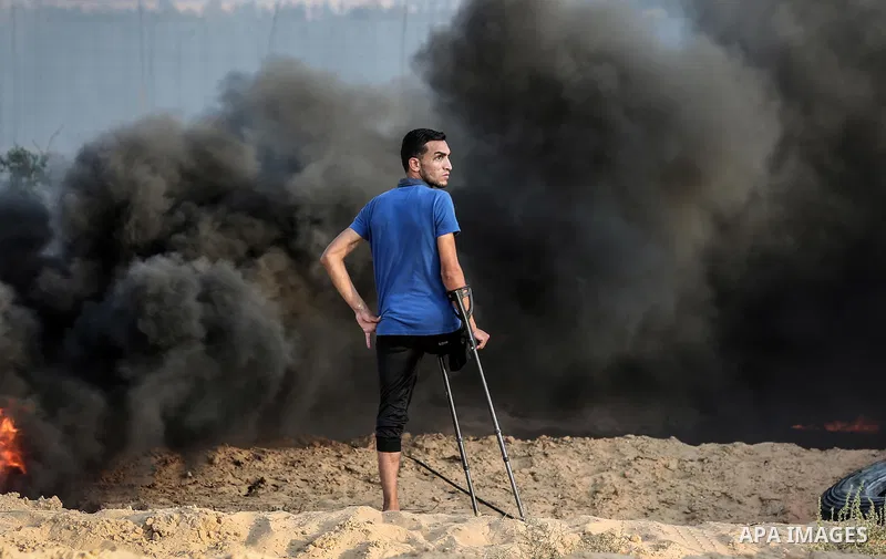 Palestinian protesters gather during clashes with Israeli troops in tents protest where Palestinians demand the right to return to their homeland at the Israel-Gaza border, in Rafah in the southern Gaza Strip on Septembe...