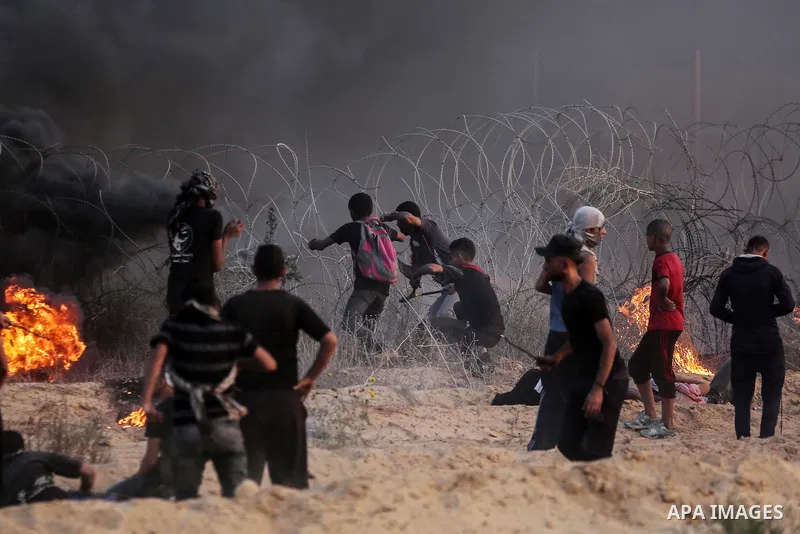 Palestinian protesters gather during clashes with Israeli troops in tents protest where Palestinians demand the right to return to their homeland at the Israel-Gaza border, in Rafah in the southern Gaza Strip on Septembe...