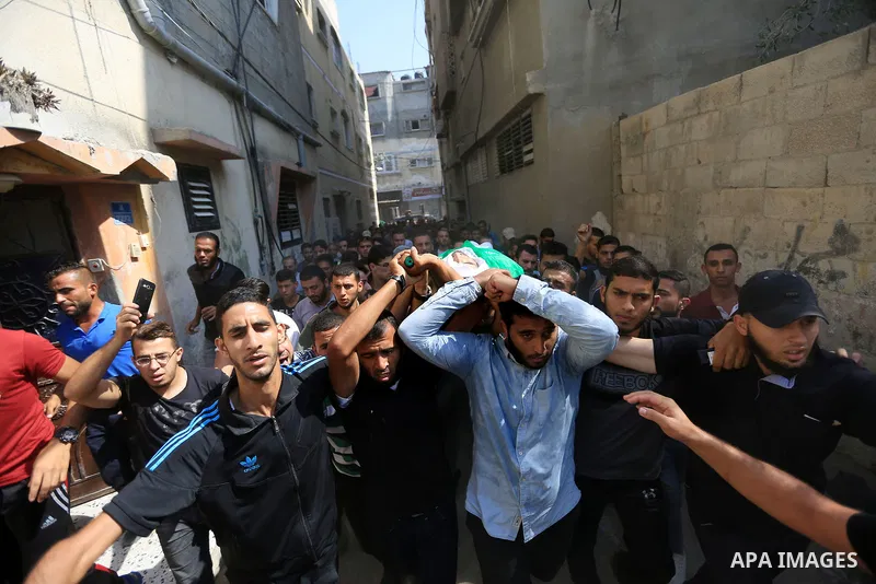 Mourners carry the body of Palestinian Mohammed Shakhsa, 24, who was shot dead by Israeli forces during clashes in tents protest where Palestinians demand the right to return to their homeland at the Israel-Gaza border,...