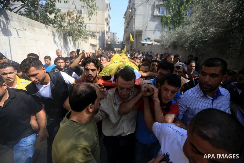 Mourners carry the body of Palestinian Iyad al-Shaer who was shot dead by Israeli forces during clashes in tents protest where Palestinians demand the right to return to their homeland at the Israel-Gaza border, during h...