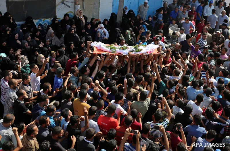 Mourners carry the body of Palestinian boy Nasser Mosabih, 12, who was shot dead by Israeli forces during clashes in tents protest where Palestinians demand the right to return to their homeland at the Israel-Gaza border...