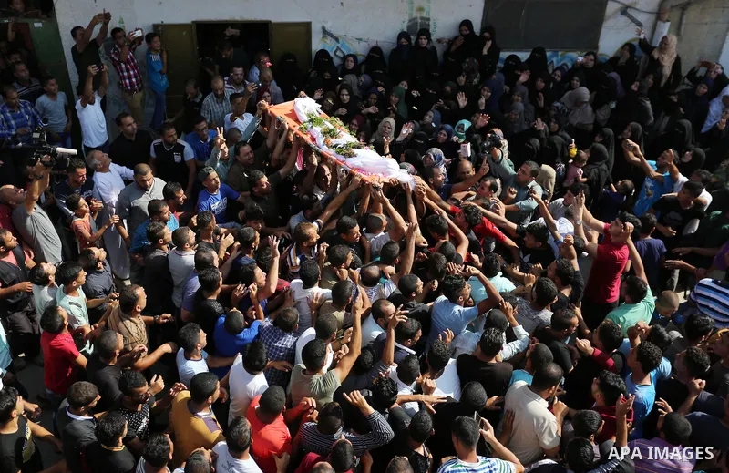 Mourners carry the body of Palestinian boy Nasser Mosabih, 12, who was shot dead by Israeli forces during clashes in tents protest where Palestinians demand the right to return to their homeland at the Israel-Gaza border...