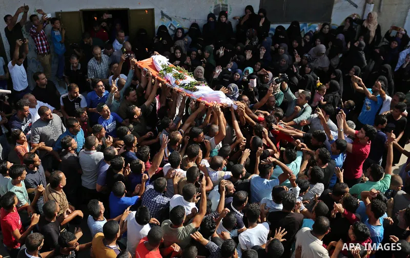 Mourners carry the body of Palestinian boy Nasser Mosabih, 12, who was shot dead by Israeli forces during clashes in tents protest where Palestinians demand the right to return to their homeland at the Israel-Gaza border...