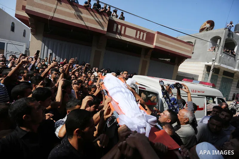 Mourners carry the body of Palestinian boy Nasser Mosabih, 12, who was shot dead by Israeli forces during clashes in tents protest where Palestinians demand the right to return to their homeland at the Israel-Gaza border...