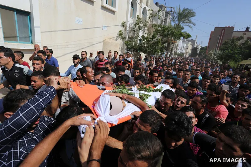 Mourners carry the body of Palestinian boy Nasser Mosabih, 12, who was shot dead by Israeli forces during clashes in tents protest where Palestinians demand the right to return to their homeland at the Israel-Gaza border...