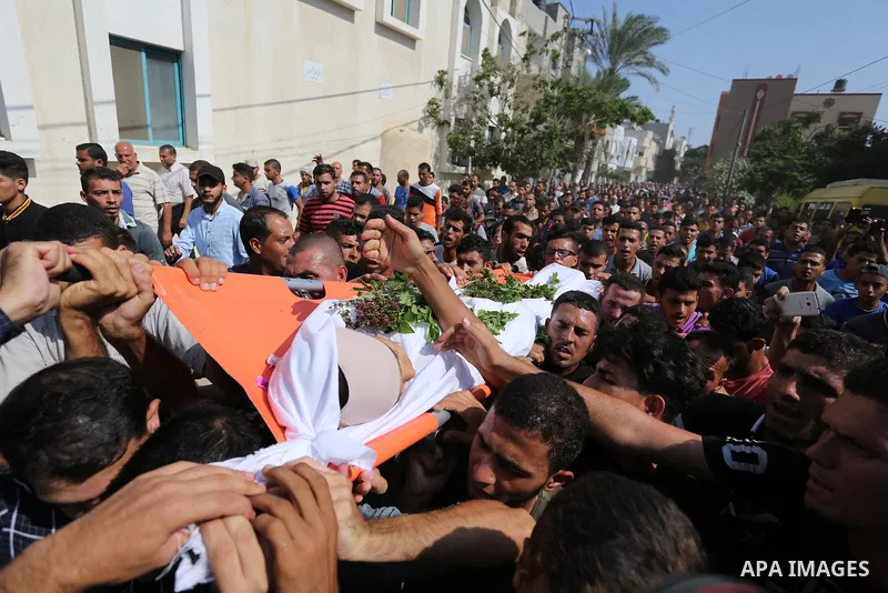 Mourners carry the body of Palestinian boy Nasser Mosabih, 12, who was shot dead by Israeli forces during clashes in tents protest where Palestinians demand the right to return to their homeland at the Israel-Gaza border...