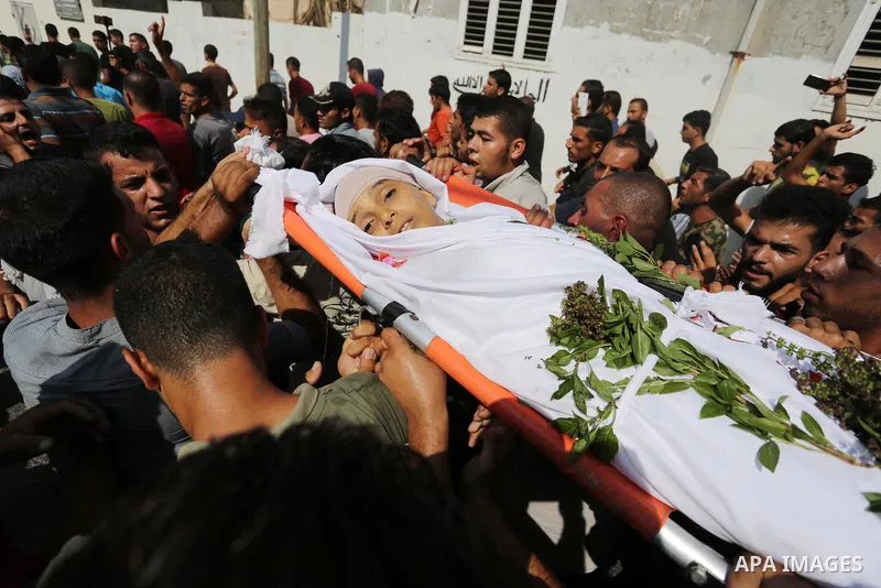 Mourners carry the body of Palestinian boy Nasser Mosabih, 12, who was shot dead by Israeli forces during clashes in tents protest where Palestinians demand the right to return to their homeland at the Israel-Gaza border...