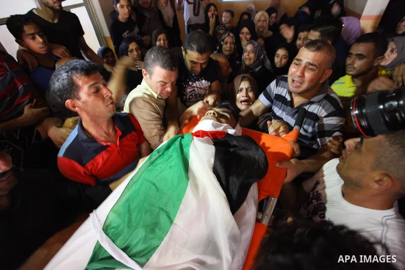 Mourners carry the body of Palestinian Iyad al-Shaer who was shot dead by Israeli forces during clashes in tents protest where Palestinians demand the right to return to their homeland at the Israel-Gaza border, during h...