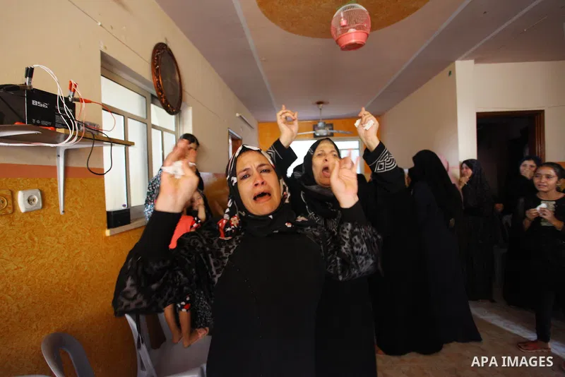 Relatives of Palestinian Iyad al-Shaer who was shot dead by Israeli forces during clashes in tents protest where Palestinians demand the right to return to their homeland at the Israel-Gaza border, mourn during his funer...