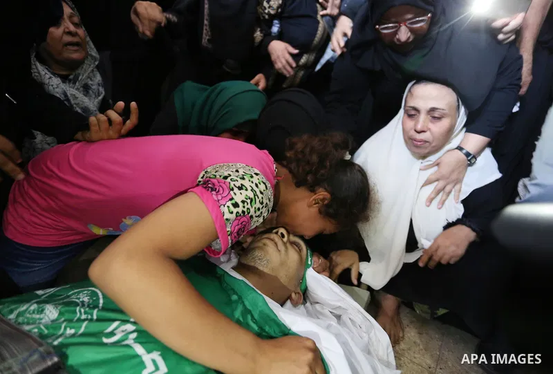 Relatives of Palestinian Mohammed Anshasi, 18, who was shot dead by Israeli forces during clashes in tents protest where Palestinians demand the right to return to their homeland at the Israel-Gaza border, mourn over his...