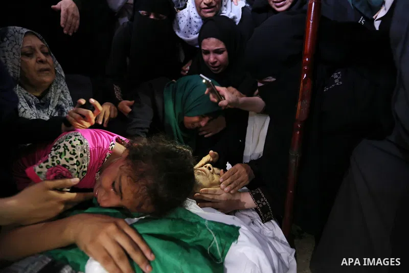 Relatives of Palestinian Mohammed Anshasi, 18, who was shot dead by Israeli forces during clashes in tents protest where Palestinians demand the right to return to their homeland at the Israel-Gaza border, mourn over his...